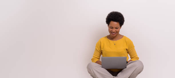 istock Smiling female manager analyzing report over laptop while sitting on isolated white background 1798503257