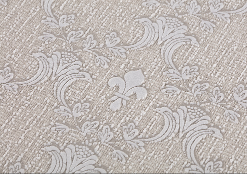 Background of light beige paper wallpaper with textured dark geometric patterns.