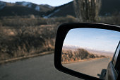 Mountain road in rear view mirror