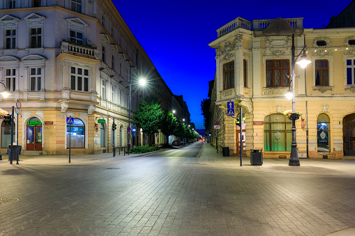 Lodz, Poland - August 24, 2023: Beautiful architecture of Piotrkowska Street in Lodz city at dawn, one of the longest commercial thoroughfares in Europe, with a length of around 4.2 km. Poland