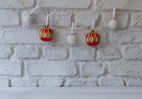 Christmas or New Year decorations background with red, gold balls hanging from a wall