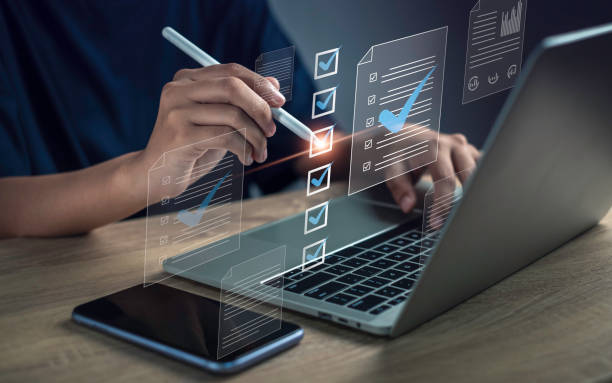 istock Document management checklist digital online form concept. Online survey filling out and digital survey and business approve project. Businessman using pen to tick correct sign mark in checkbox. 1798532601