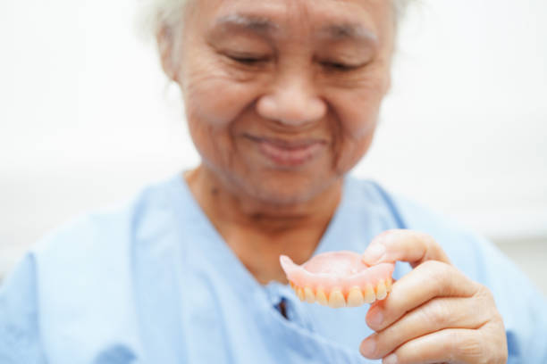 istock Doctor holding teeth denture in hand for dentist studying about dentistry. 1798545391