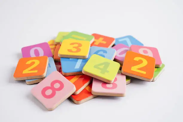 Photo of Number wood block cubes for learning Mathematic, education math concept.