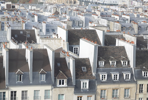 View of city rooftops in the rain in Paris, France.