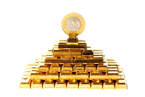 100 Kazakhstan tenge coin and pyramid of gold bars
