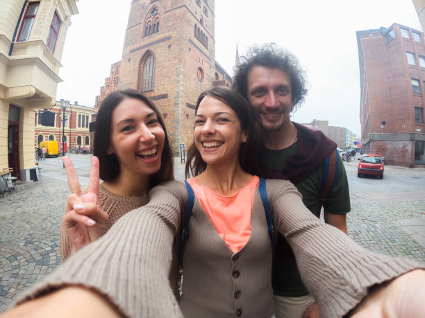 istock Three Young Friends Taking Selfies On The Stortorget Square In Malmo In Sweden 1798557553
