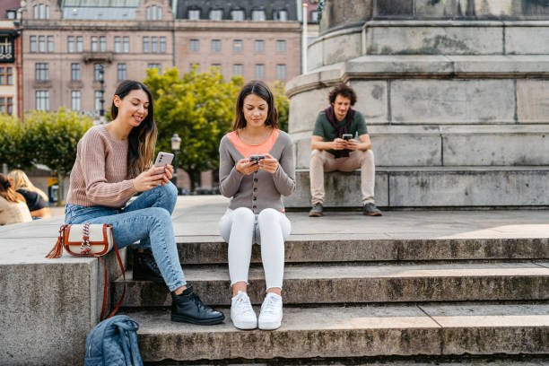 istock Three People Using Their Phones In Malmo In Sweden 1798561945