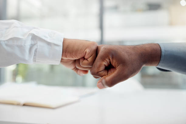 istock Hands, motivation and collaboration fist bump hand gesture, sign or icon with teamwork, support and collaboration. Diversity worker group or business people together in unity, solidarity and welcome 1798564139