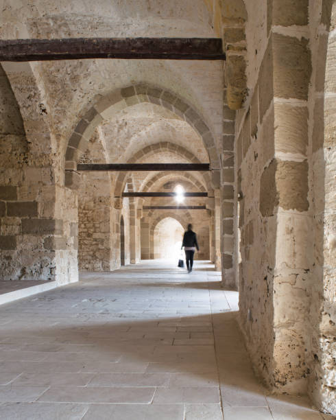 istock Stone brick hallway lit by natural light streaming in through narrow windows, Citadel of Qaitbay, Alexandria, Egypt 1798572916