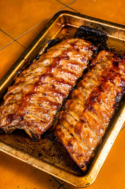 istock Barbecue grilled pork spare ribs. Orange background. Top view 1798572978