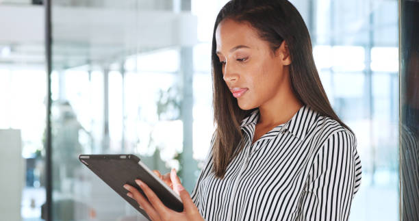 istock Business, office and woman with tablet, connection and network with email notification, website info and internet. Productivity, person or employee with technology, working or typing with digital app 1798582785