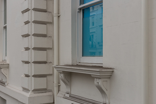 Vintage window ledge with blue shade covering the window in central London