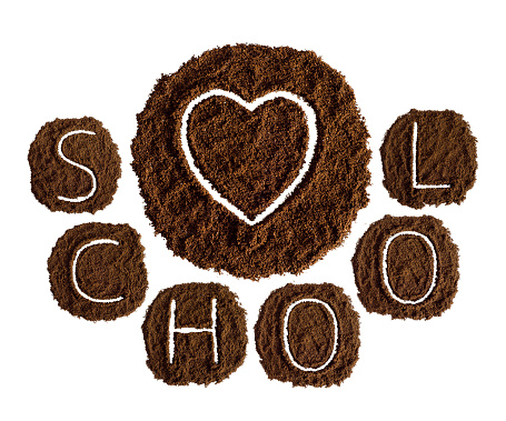 Alphabet decorated with ground coffee on white background