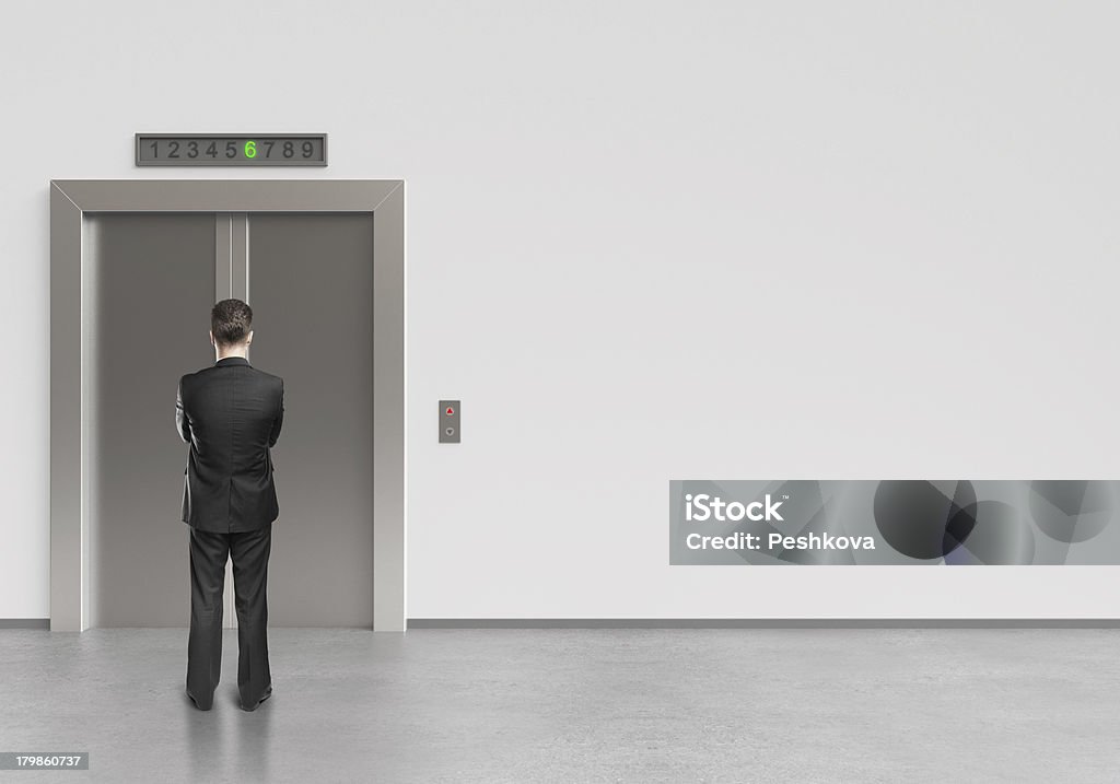 man and elevator businessman and modern elevator with closed doors Adult Stock Photo