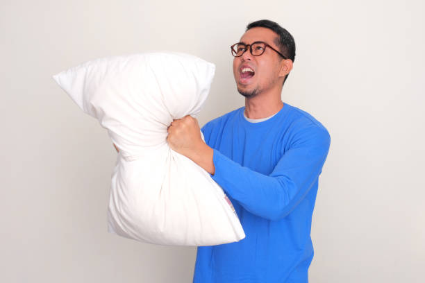 istock Adult Asian man screaming mad while crushing a pillow 1798618725