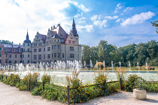 Moszna, Poland - September 18, 2023: Palace in Moszna. Historic residence located in the Opole Voivodeship. Upper Silesia. Beautiful view of the castle against the blue cloudy sky. Tourist and Historical Attraction.