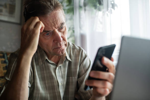 istock Worried senior man looking at smartphone at home 1798622053