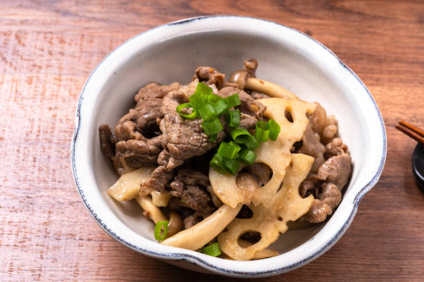 Stir-fried sweet and spicy beef and lotus root stock photo