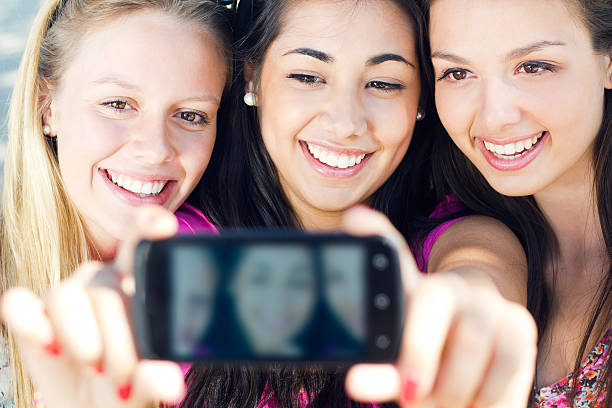 istock three friends taking photos with a smartphone 179862733