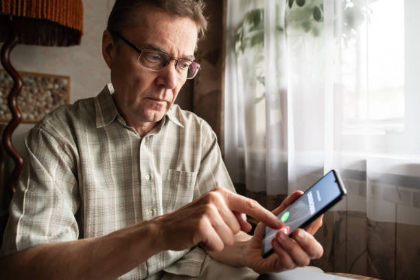 istock Senior man refuses to answer to a call from unknown number. Scam and fraud prevention with smartphone concept. 1798628272