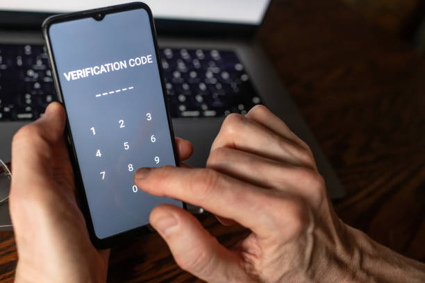 istock Senior man at home entering verification code in smartphone, fraud prevention concept. 1798629970