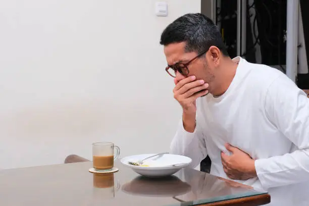 A man get nauseous when eating food