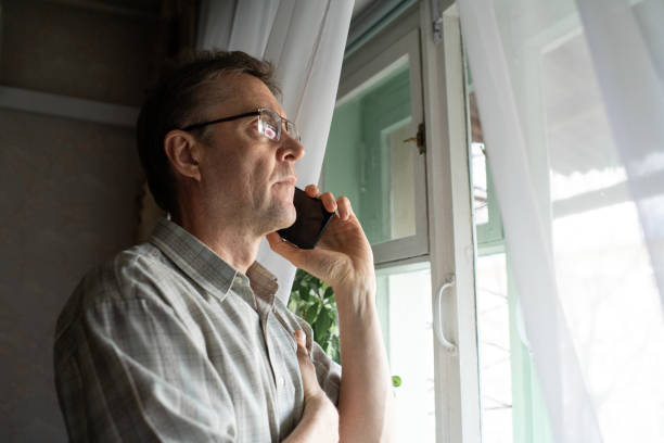 istock Senior man talking by phone at home 1798630861