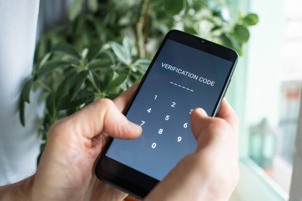 istock Serious senior man at home entering verification code in smartphone, fraud prevention concept. 1798631097