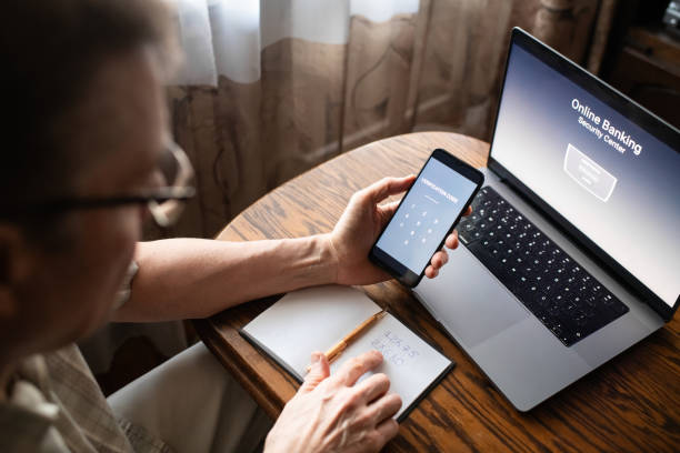 istock Serious senior man at home entering verification code in smartphone, fraud prevention concept. 1798632241