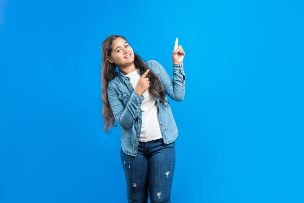 istock Indian girl pointing fore fingers upwards 1798632280