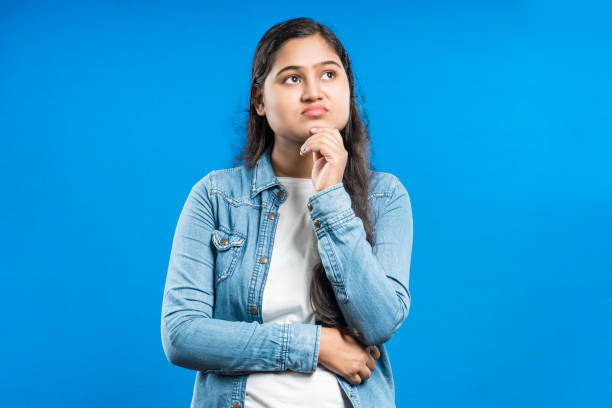 istock Indian young female touching her chin and thinking 1798632808
