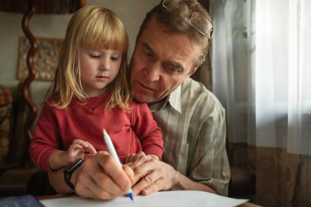 istock Child with grandfather spending time together at home 1798634023