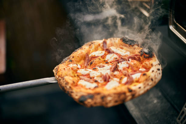 istock A freshly made pizza, right from the oven, with a smoke all around. 1798647293