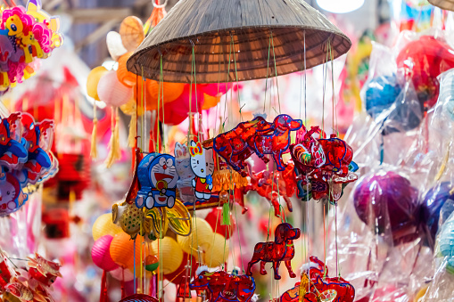 Ho Chi Minh City, Vietnam - Sep 1 2023: Decorated colorful lanterns hanging on a stand in the streets in Ho Chi Minh City, Vietnam during Mid Autumn Festival. Selective focus.