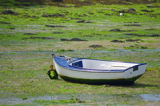 Single boat at low tide