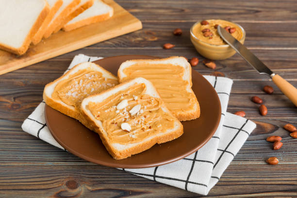 Peanut butter sandwiches or toasts on light table background.Breakfast. Vegetarian food. American cuisine top view vith copy space