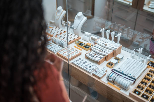 Hispanic Female Window Shopping at the Jewelry Store Hispanic female enjoys a relaxed window shopping experience at a jewelry store, adding a touch of leisure to their day. jewelry store stock pictures, royalty-free photos & images
