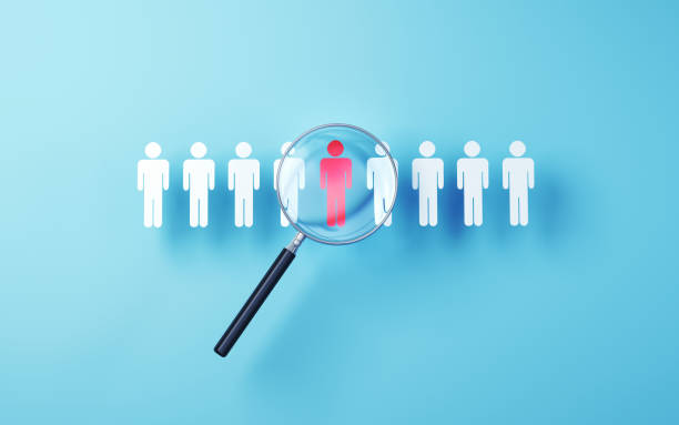 istock Selected human icon in metallic magnifying glass on soft blue background 1798670306