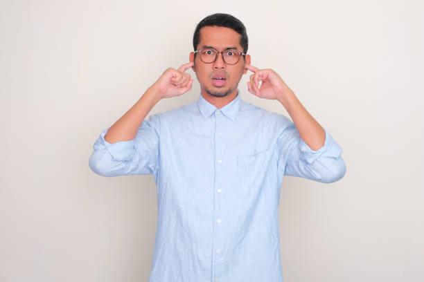 istock Adult Asian man closing both ears with finger with annoyed expression 1798677265