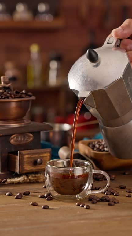 Man hand pouring coffee from a geyser coffee maker