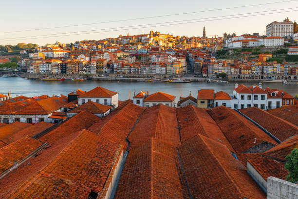 Porto, Portugal old town on the Douro River with orange rooftops of Vila Nova de Gaia buildings at sunrise. Medieval architecture of Oporto downtown. Travel destination Porto, Portugal old town on the Douro River with orange rooftops of Vila Nova de Gaia buildings at sunrise. Medieval architecture of Oporto downtown. Travel destination vila nova de gaia stock pictures, royalty-free photos & images