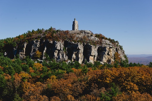 Mohunk, United States – October 29, 2022: A scenic view of the autumn Mohonk Preserve, featuring a tall mountain with trees at the top