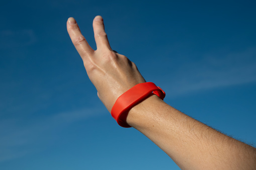 Waterproof key bracelet. Functional gadget RFID wristband on female hand.