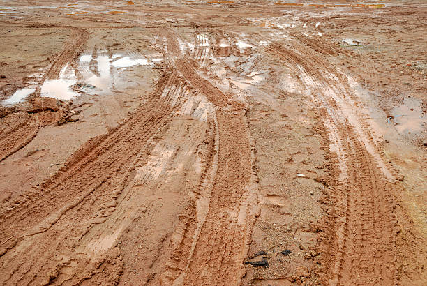 istock muddy road with tire trail 179870578