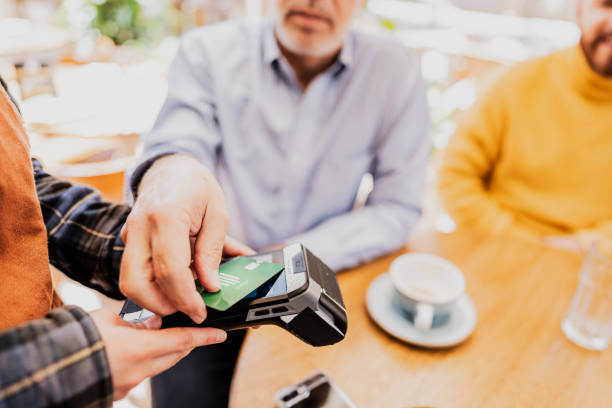 istock Man's hand paying with credit card in the restaurant 1798726644