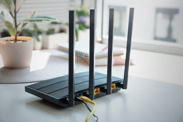 istock Modern wi-fi router on light table in room 1798728280