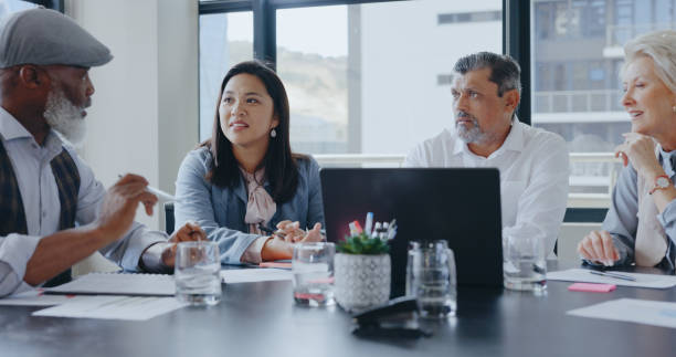 istock Teamwork, problem solving or senior business people in meeting planning strategy together. Brainstorming, leadership or mature manager in office talking or speaking of financial info or report online 1798737300