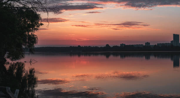 istock Sunrise on lake with clouds reflecting in water 1798744989