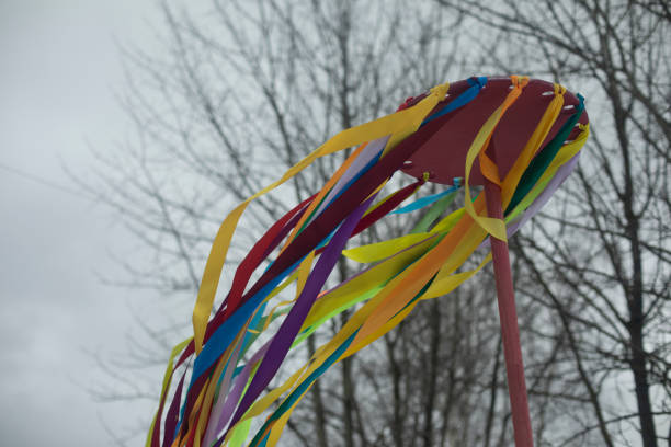 Folk Spring Festival. Colored ribbons on hoop. Totem object. Pagan rite. Ribbons in wind.